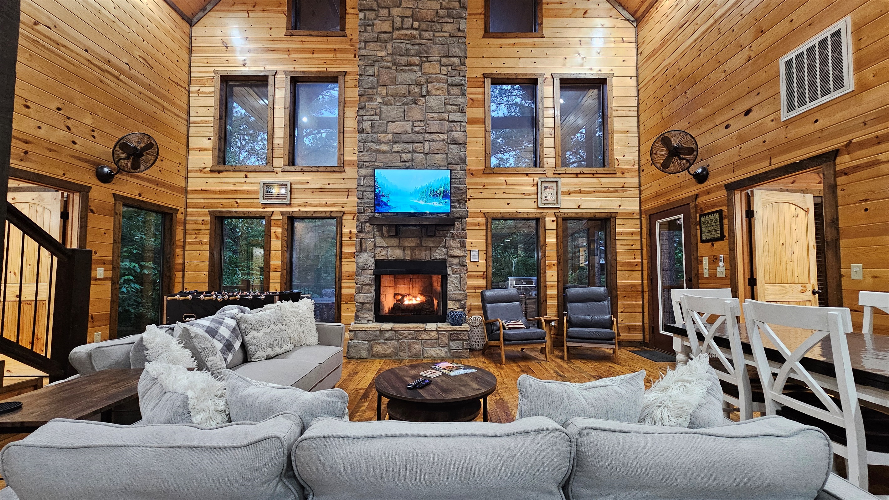 Living Room: Elegant stone fireplace and expansive windows invite nature inside for a memorable stay!