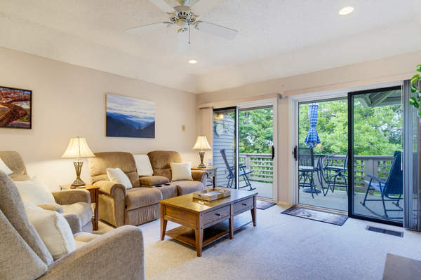 Double sliding glass doors fill the living room with natural light and provide easy access to the private deck.