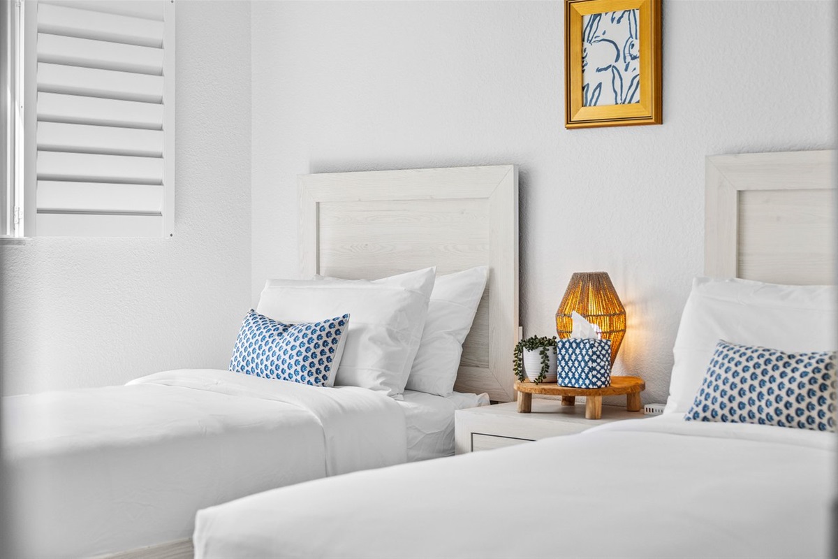 Charming and serene, this twin bedroom features soft textures and coastal accents for a peaceful, restful stay.