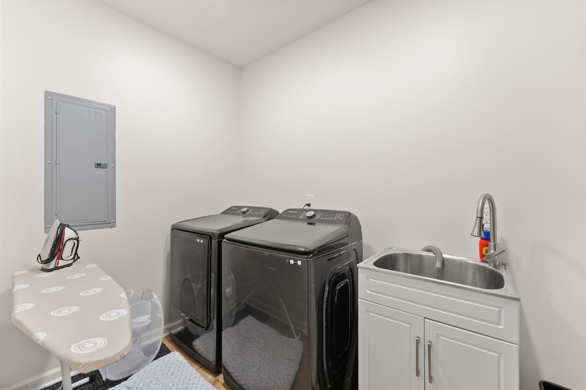 Private laundry area with washer, dryer, iron, and ironing board—everything you need for a convenient stay.