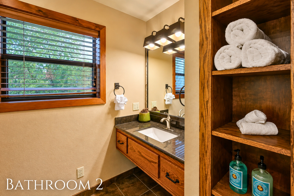 Everything you need is close at hand in this full bath, with a spacious vanity, plenty of storage, and a bright window bringing in natural light.