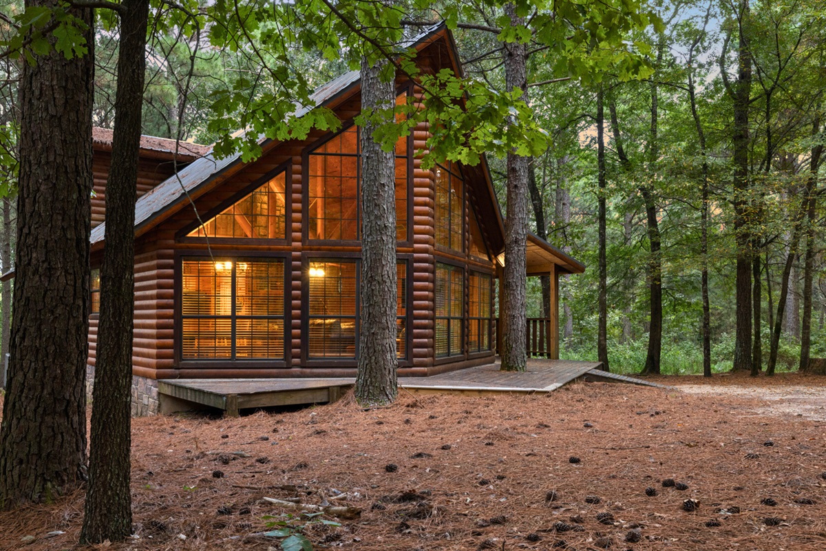 Another angle of the cabin nestled deep in the woods