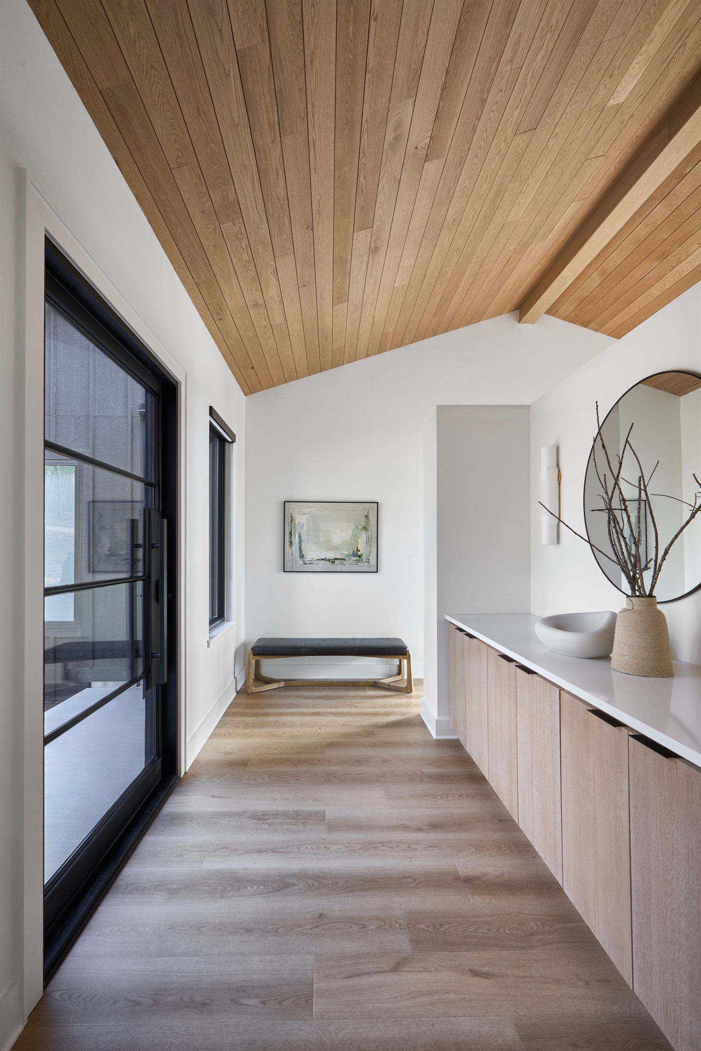 A warm and welcoming entryway with modern decor and clean lines sets the tone for a peaceful and stylish stay.