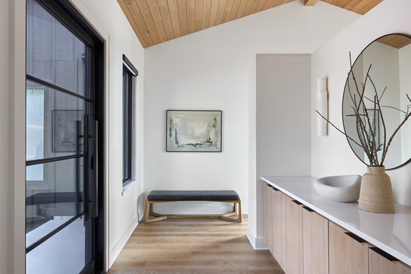 A warm and welcoming entryway with modern decor and clean lines sets the tone for a peaceful and stylish stay.
