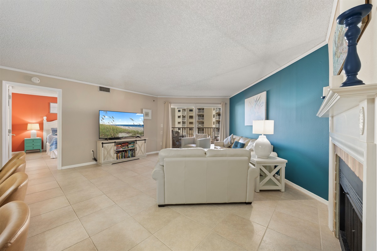 Huge open cozy living room with 70-inch LED Smart TV, Fireplace and Gulf Views
