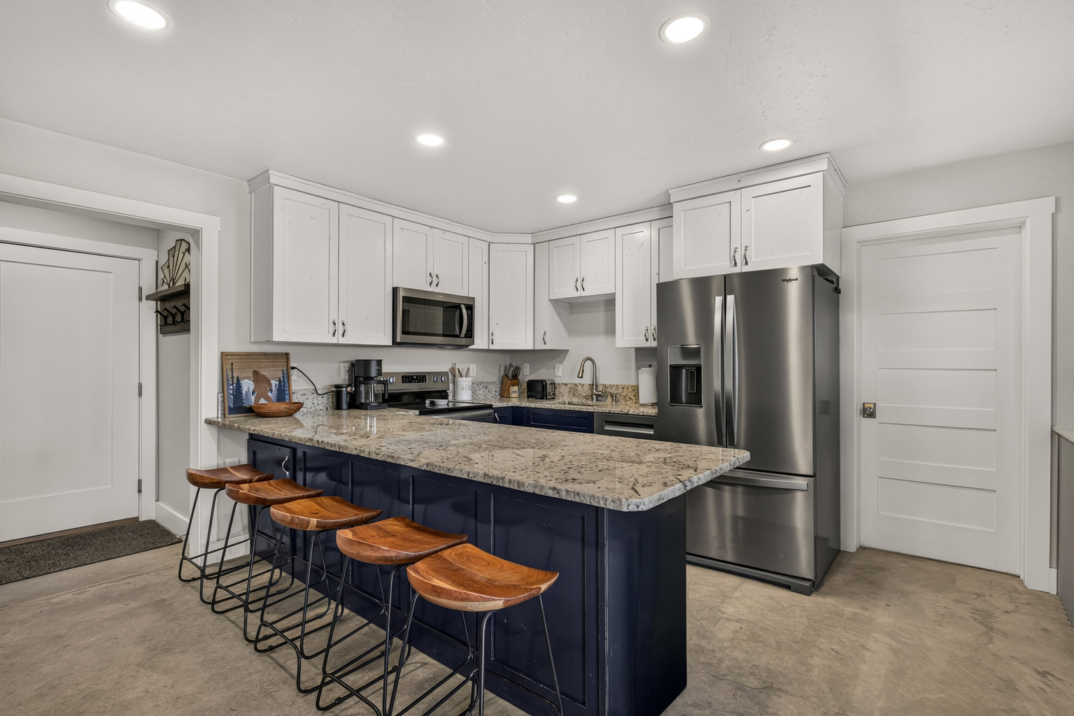 Fully equipped kitchen with extra barstool seating.