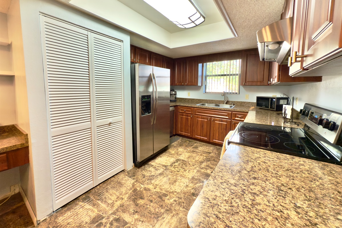 The countertops are made from gorgeous granite, offering a durable and heat-resistant surface for meal prep.