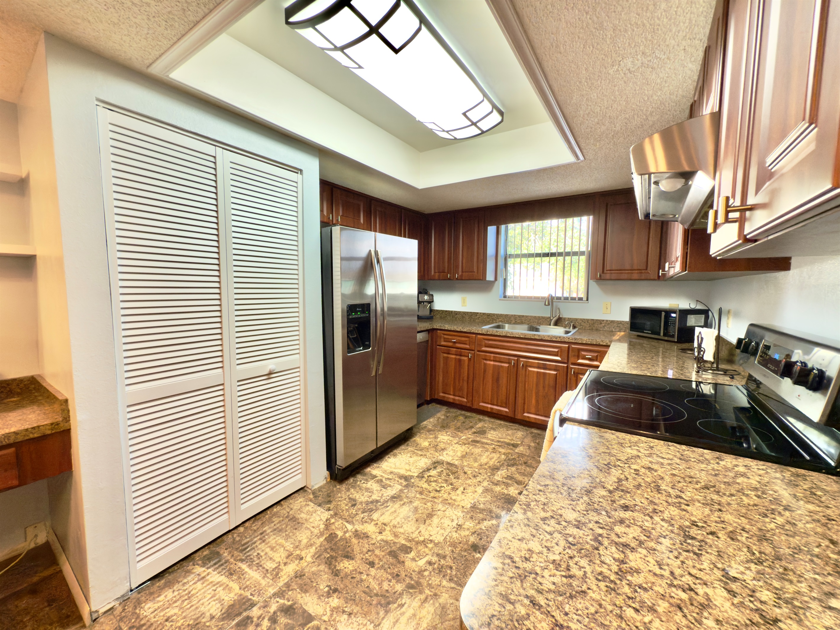 The countertops are made from gorgeous granite, offering a durable and heat-resistant surface for meal prep.