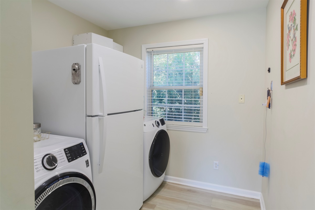 Convenient laundry room with washer, dryer, and an extra fridge for your stay.