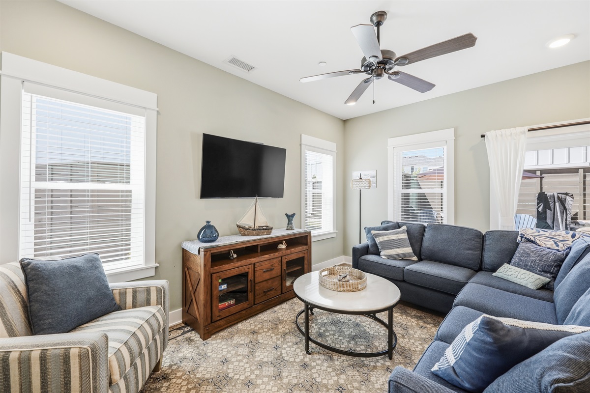 Bright and cozy living area with plenty of seating and Smart TV