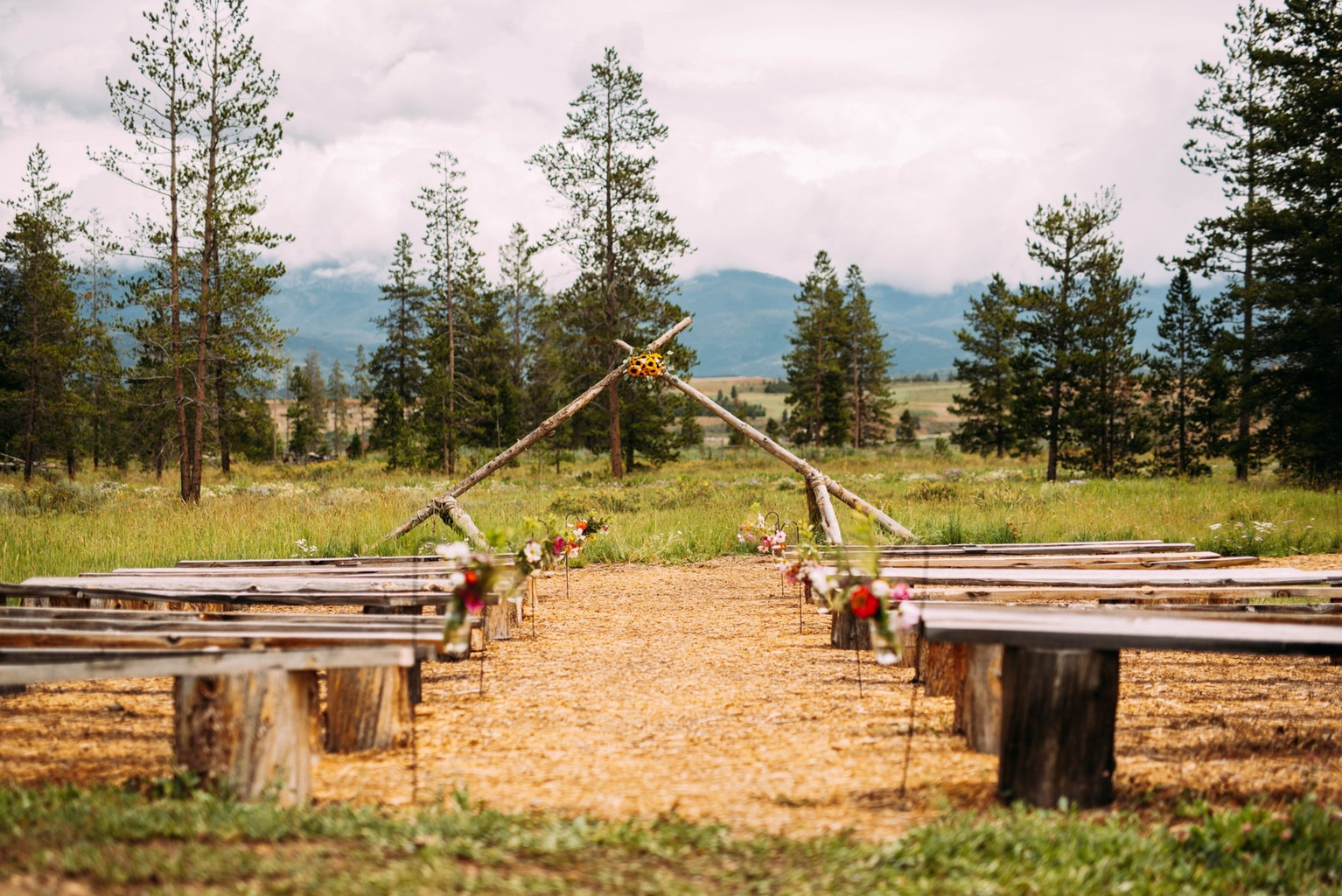 Ceremony benches and arch with mountain views at Casa Vista
