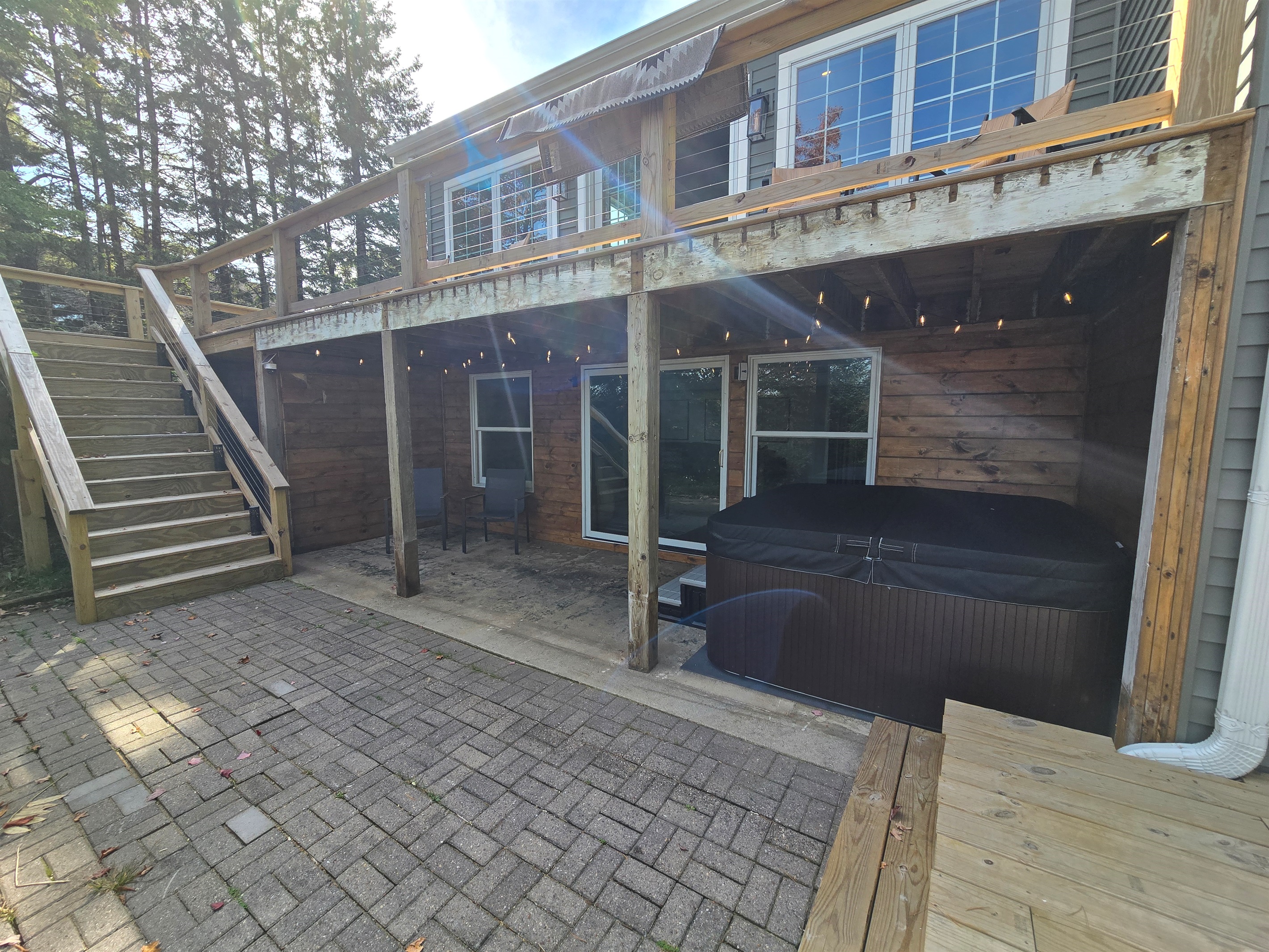 - Spacious patio with cozy seating and hot tub access   - String lights add charm for evening outdoor time   - Great spot to unwind and enjoy lakeside moments