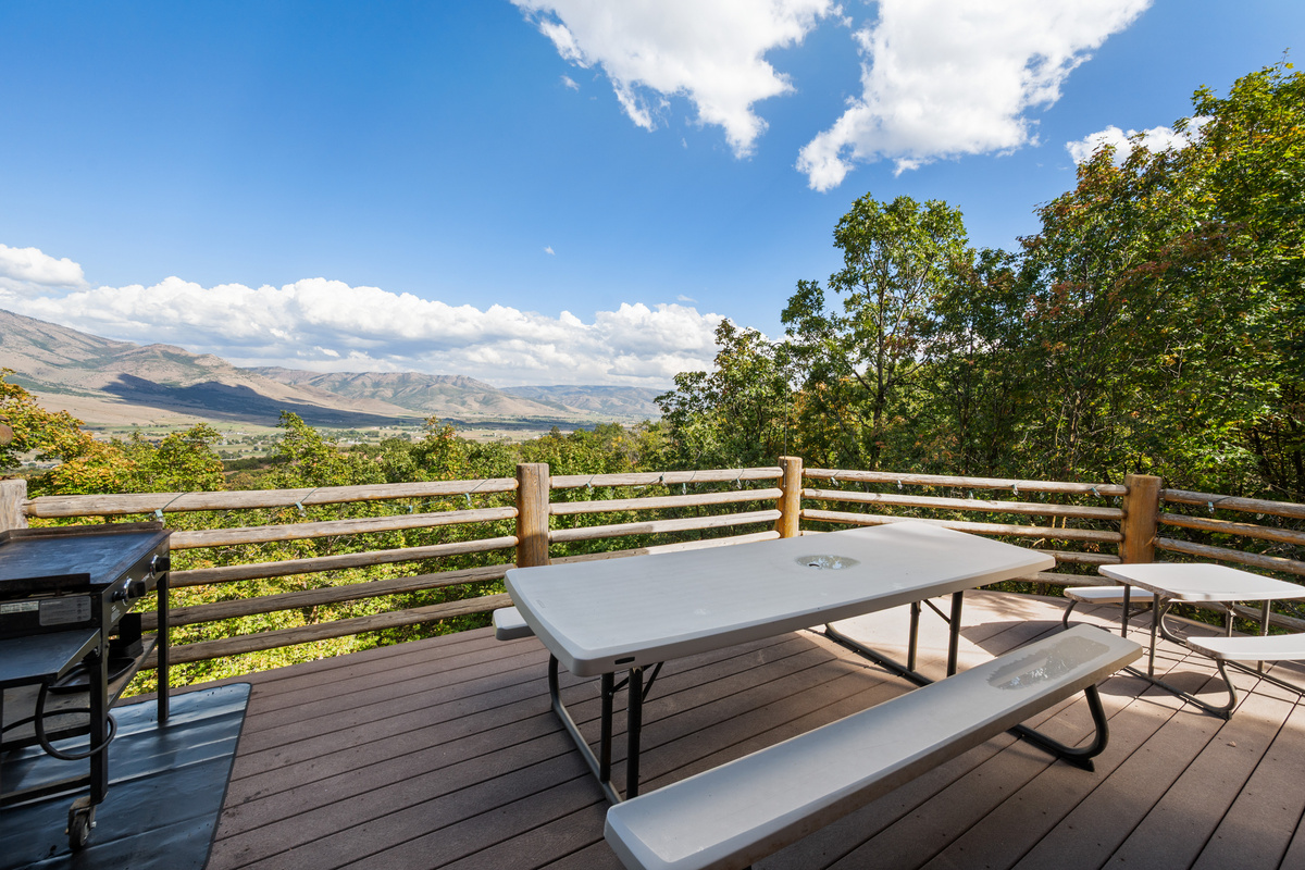 Mountain-facing deck with multiple dining areas for relaxing in the fresh air