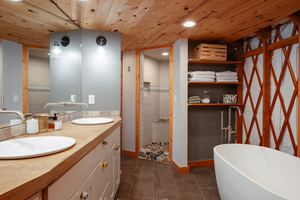 Spacious full bathroom featuring a deep soaking tub, separate walk-in shower, and modern finishes designed for comfort and relaxation.