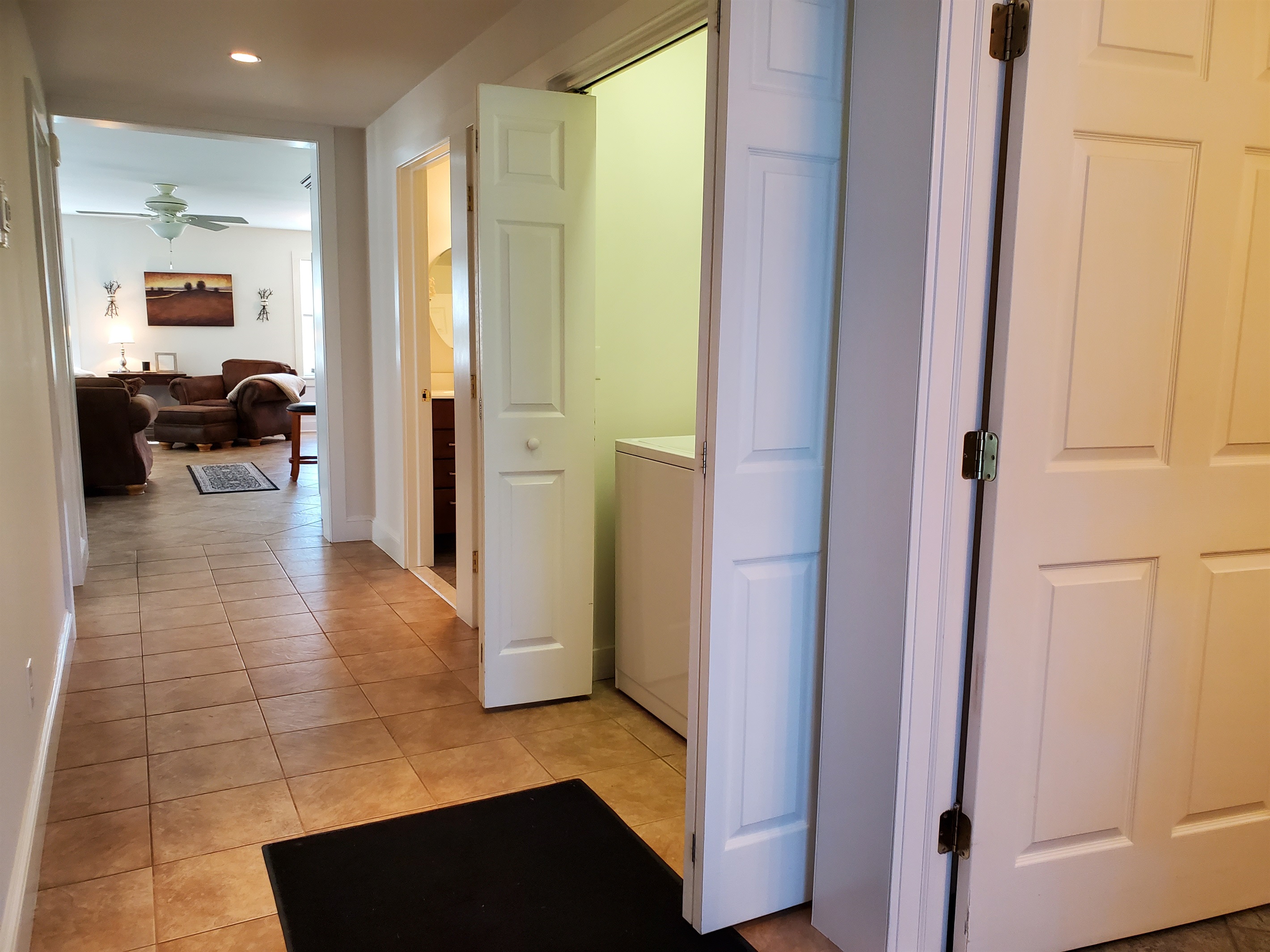 View into the living room down the hallway. See laundry area on the right.