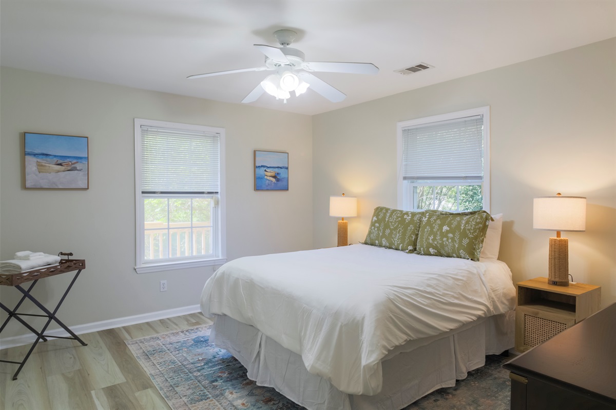 Inviting second bedroom with plush bedding and plenty of natural light.