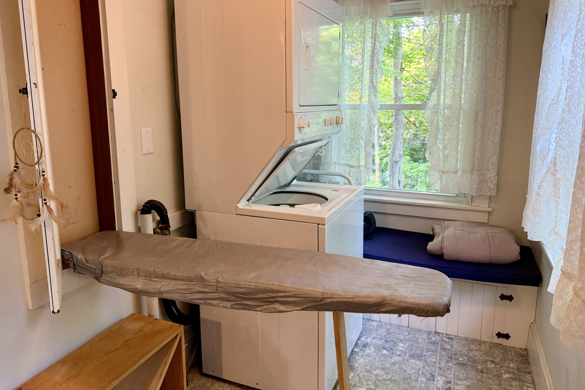 Clean clothes made easy. The laundry nook features a stacked washer and dryer alongside a clever, custom built-in fold-down ironing board. A highly functional amenity designed to keep your wardrobe fresh during longer stays on MDI.