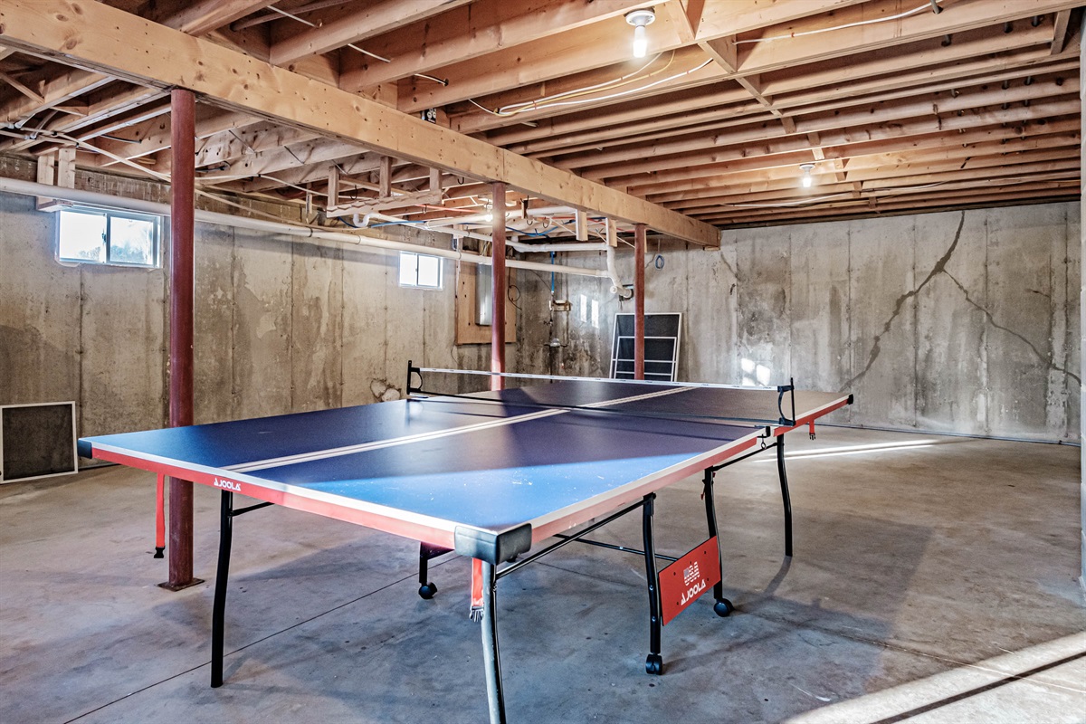 The basement game area is stocked with ping pong and darts for nonstop fun.