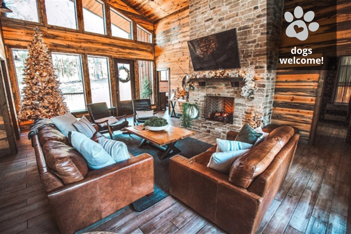 A warm and inviting living space featuring a stone fireplace, rustic wood accents, and plush seating—ideal for family gatherings and cozy nights in.