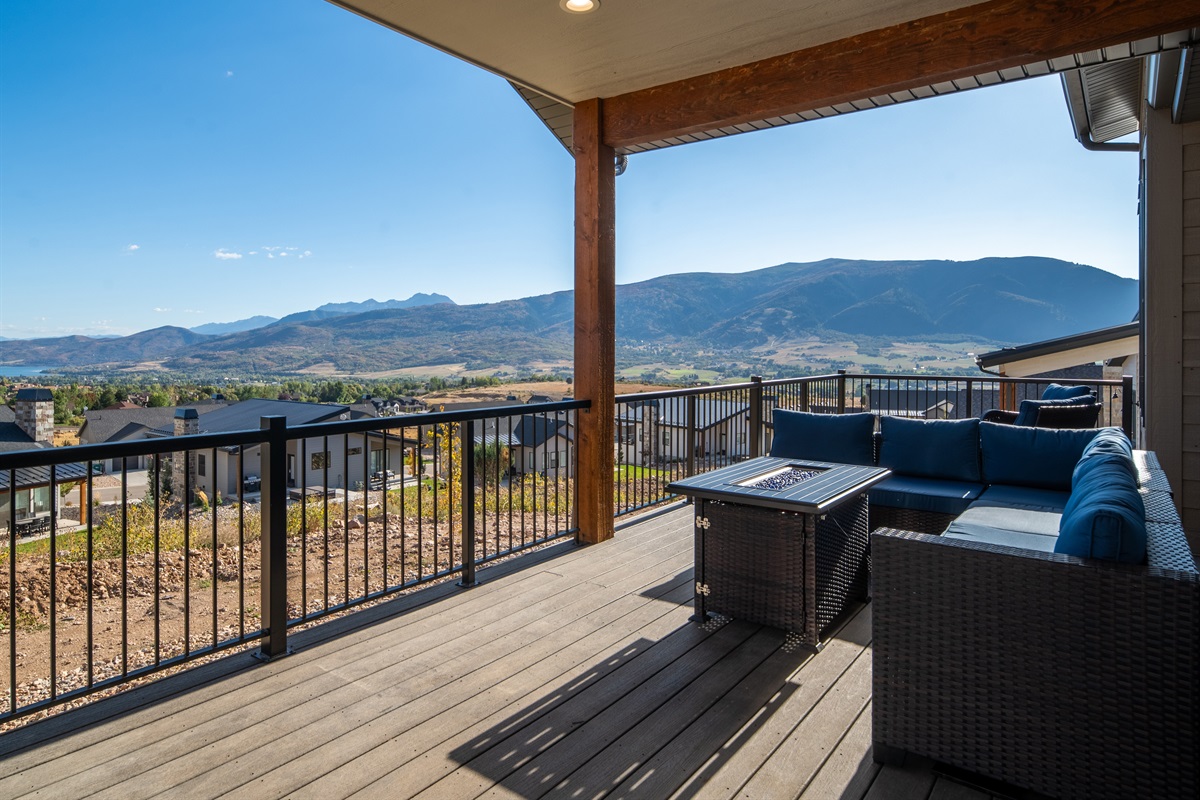 Covered deck seating with a fun firepit—ideal for morning coffee or evening fun with s'mores.