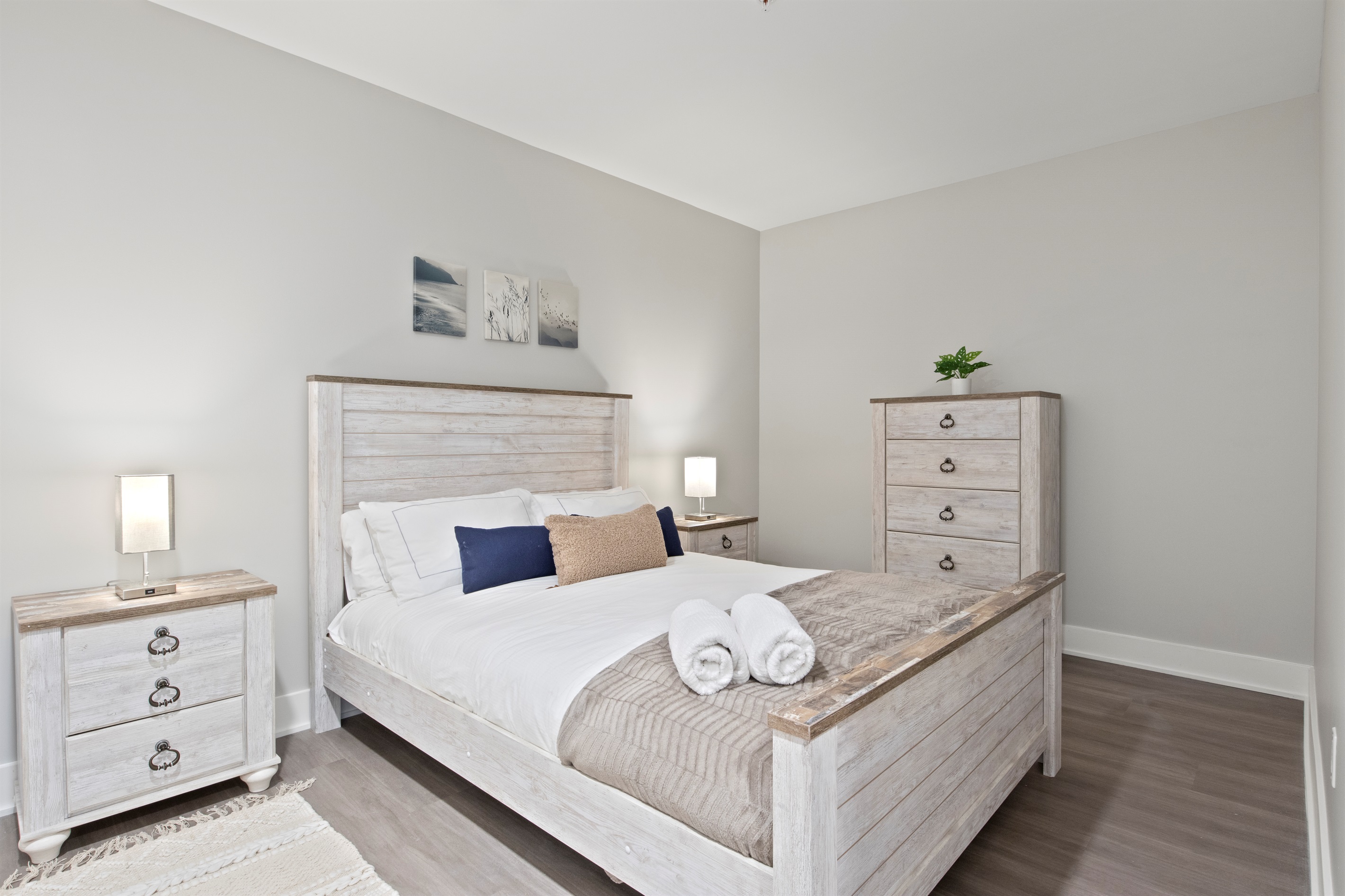 Unwind in this peaceful bedroom featuring rustic farmhouse furniture, cozy lighting, and soft neutral tones — the perfect Finger Lakes retreat after a day of wine tasting or lake adventures.