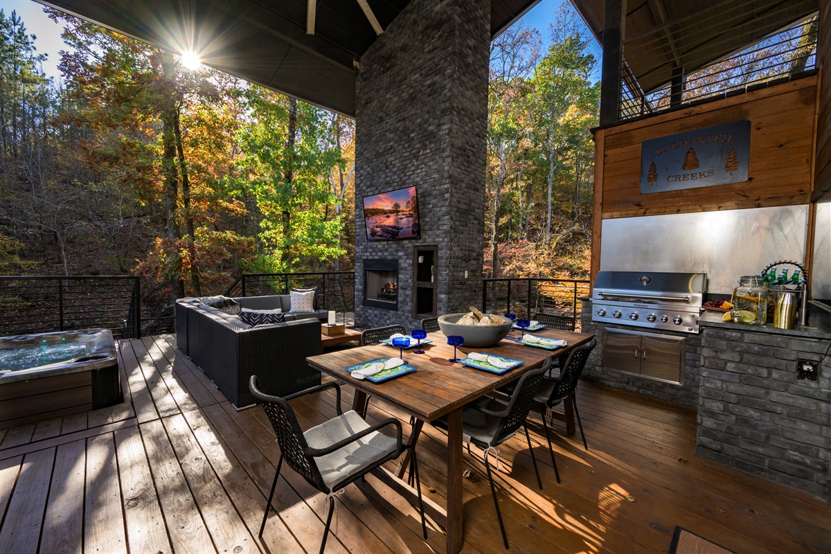 Outdoor living at its finest — dine, grill, and unwind by the fireplace surrounded by peaceful forest views