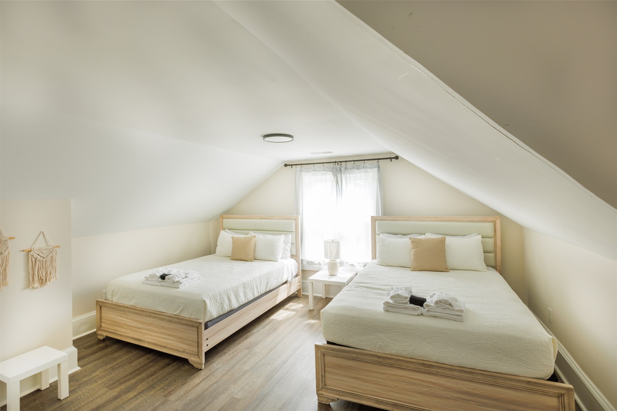 2 Queen Bedroom with clothing storage, bedside lights.