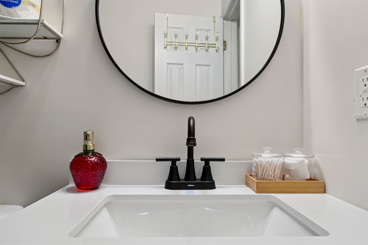 Full bathroom thoughtfully stocked with essentials including body wash, shampoo, conditioner, cotton pads, and Q-tips everything you need for a comfortable and refreshing stay.