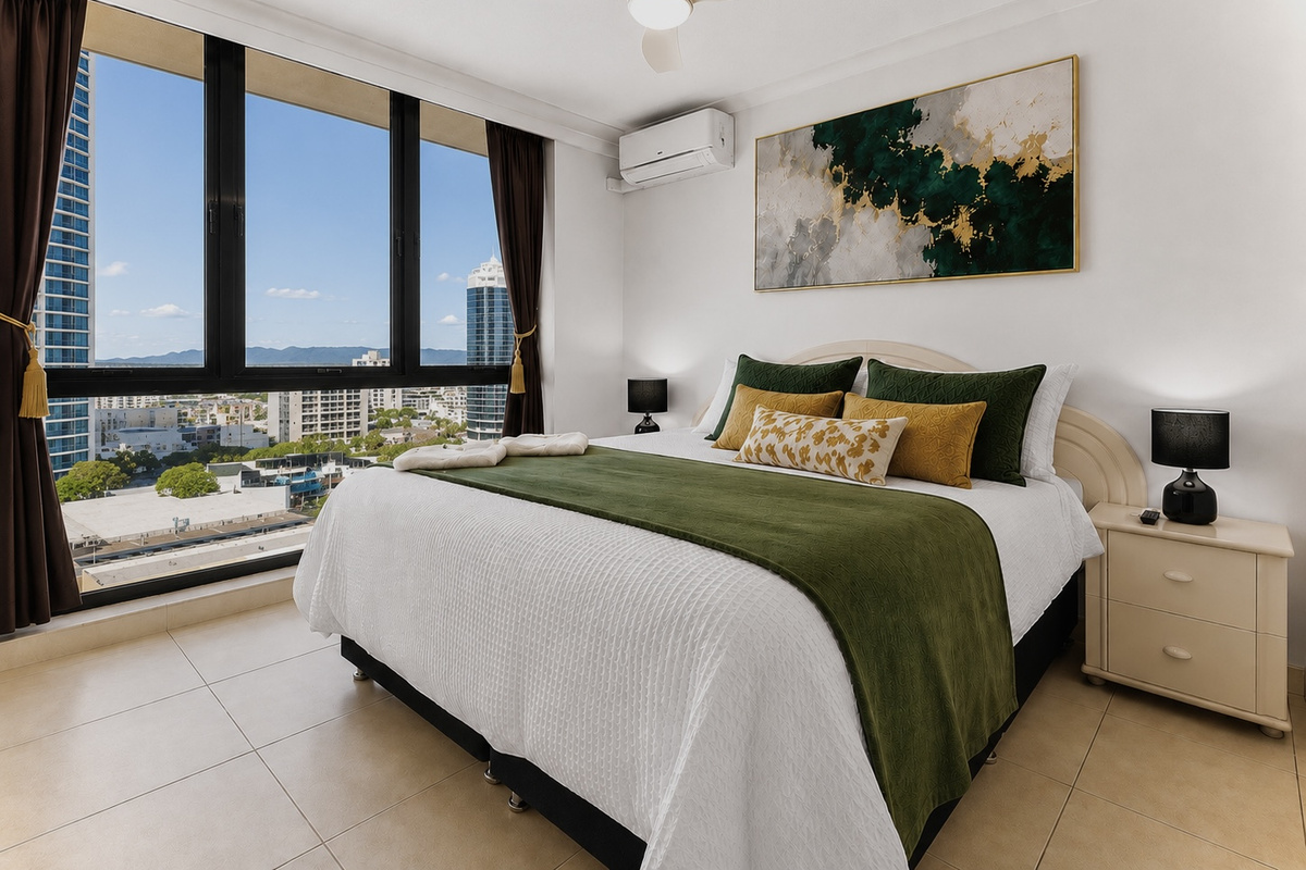 This king bedroom is set up with premium linen, blackout curtains, air conditioning and a ceiling fan separated from the open-plan living area.