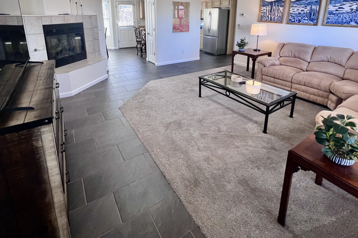 The home's open floor plan seamlessly connects the kitchen, living room, and dining room, creating a spacious and airy feel perfect for entertaining and spending time together.