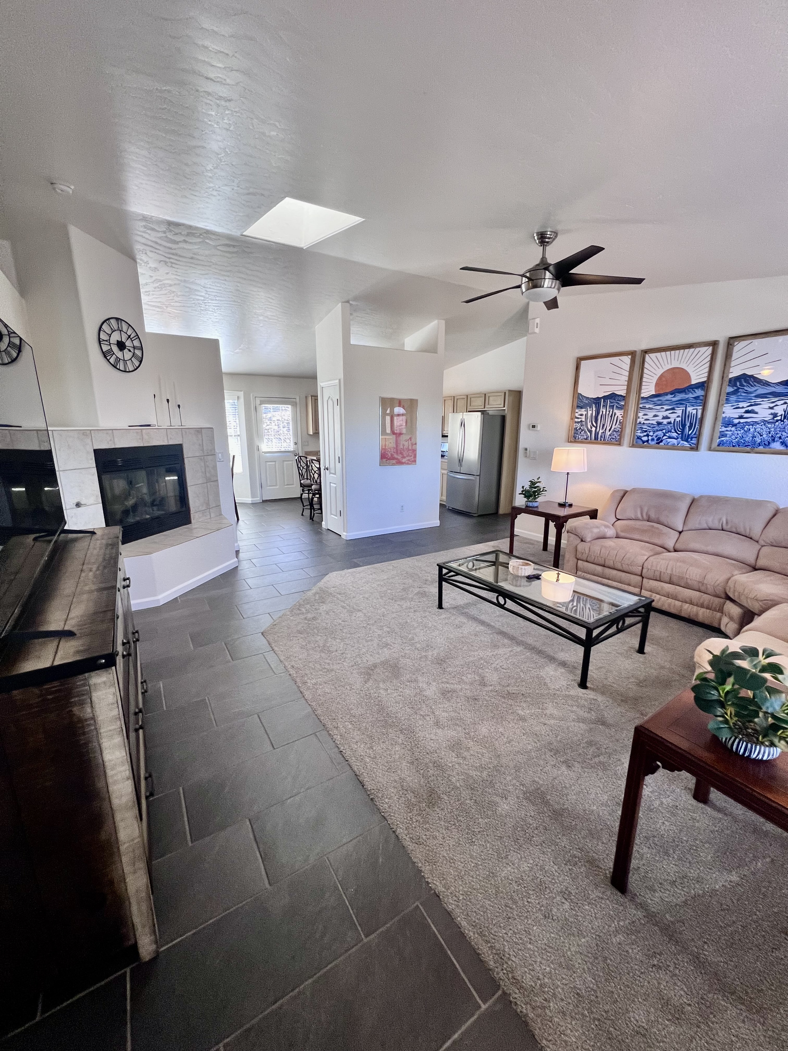 The home's open floor plan seamlessly connects the kitchen, living room, and dining room, creating a spacious and airy feel perfect for entertaining and spending time together.