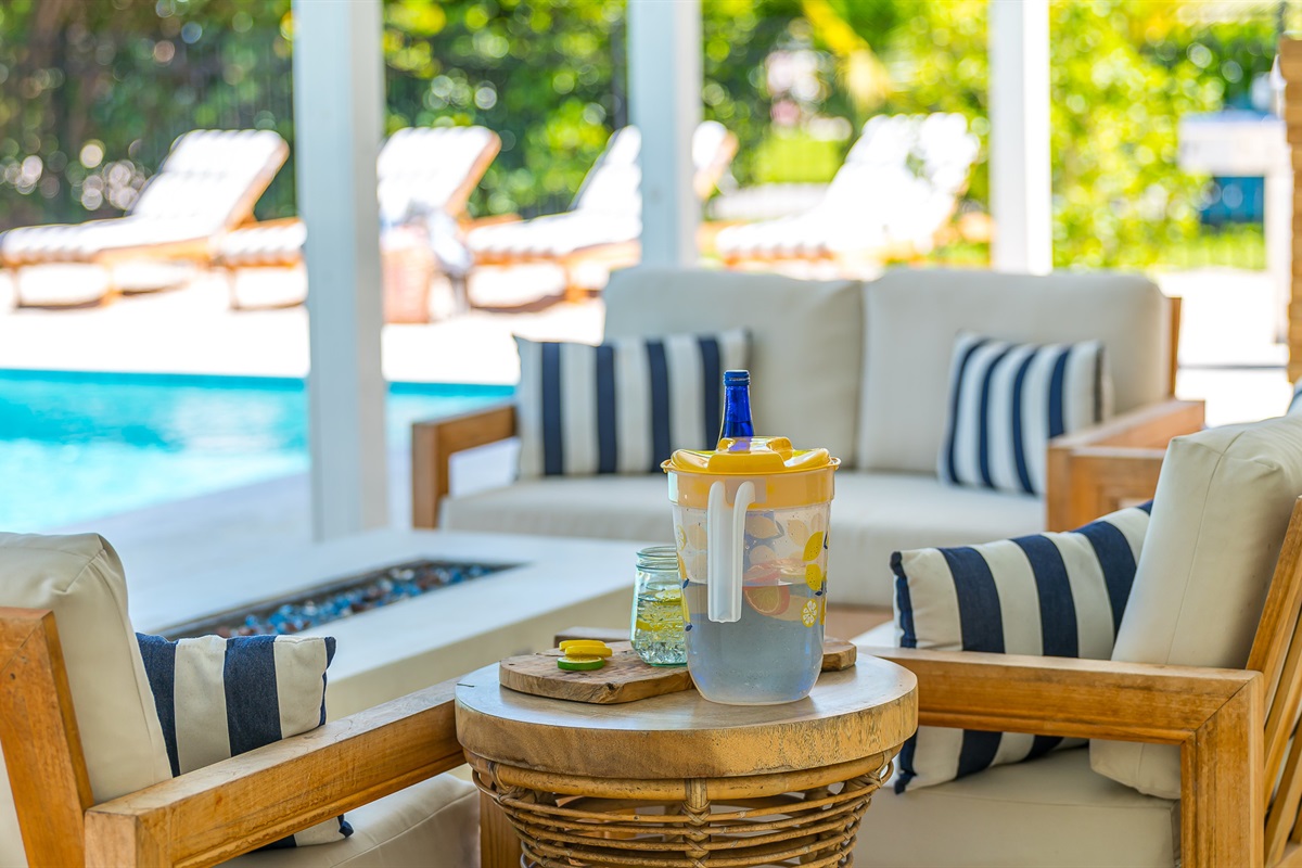 The pool deck is finished in shell white limestone, offering a beautiful natural backdrop.  By night, enjoy the tiki bar, TV, fire table, and the glow of the Jupiter Lighthouse Beacon 