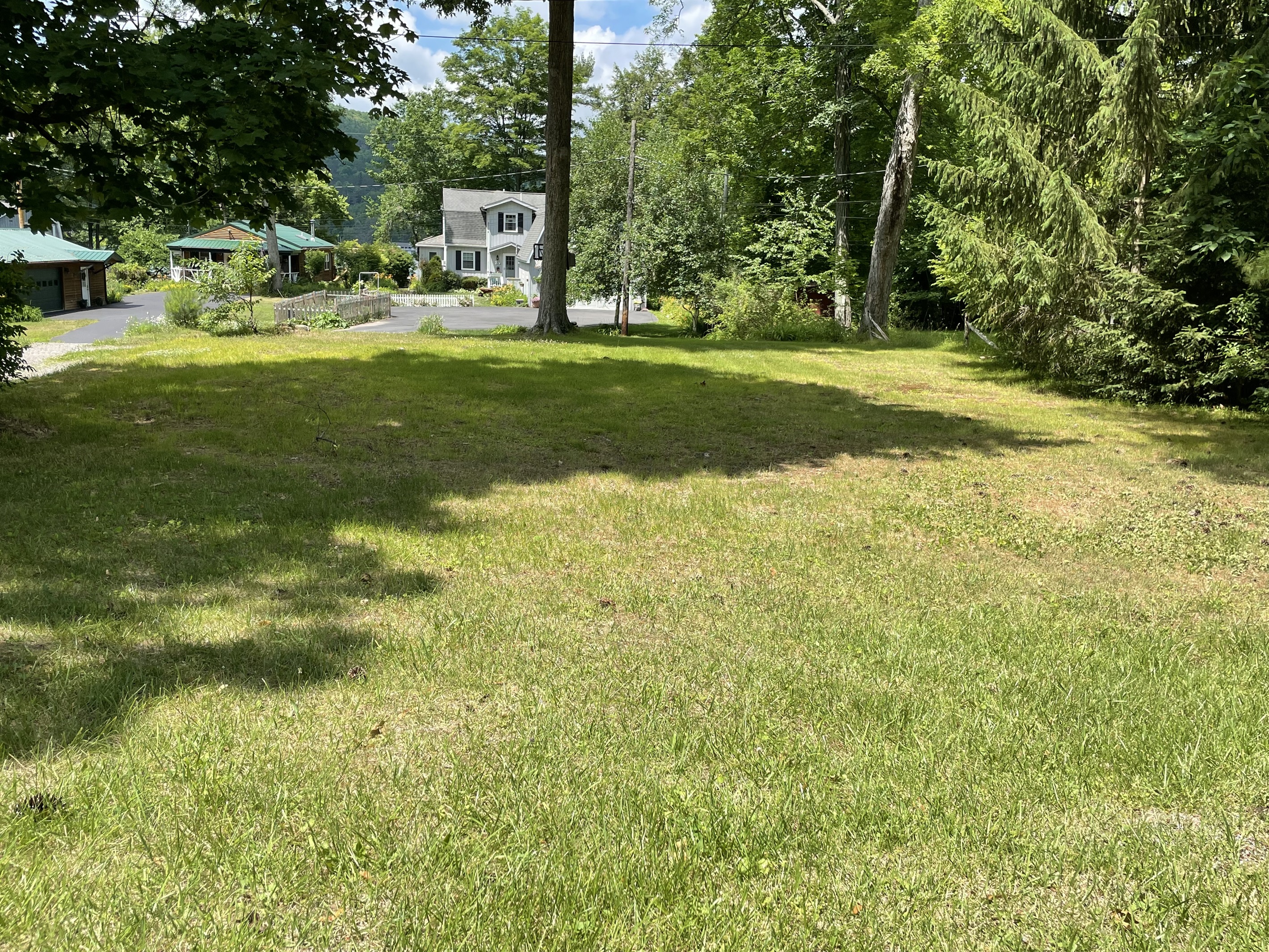View from the road, large lawn leading to the house.