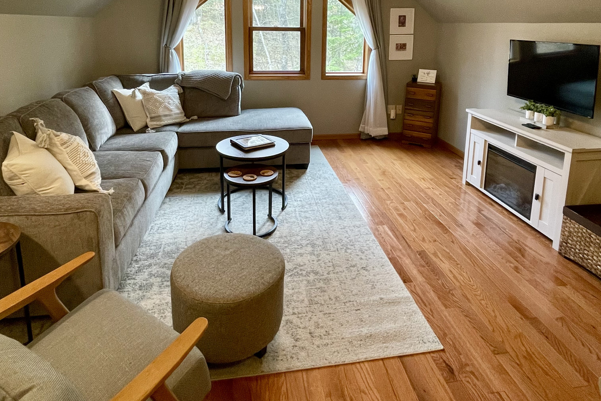 Rock Garden Cottage 
Upper level open concept kitchen living room with queen sofa sleeper sofa. Large window and electric fireplace 