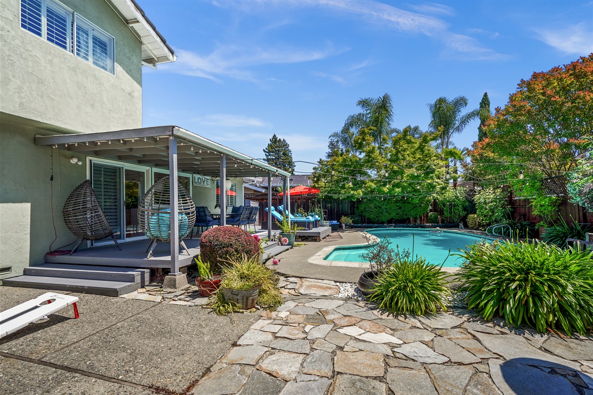 Private backyard retreat with a sparkling pool, outdoor seating, and space to relax and enjoy Napa Valley’s beautiful weather.