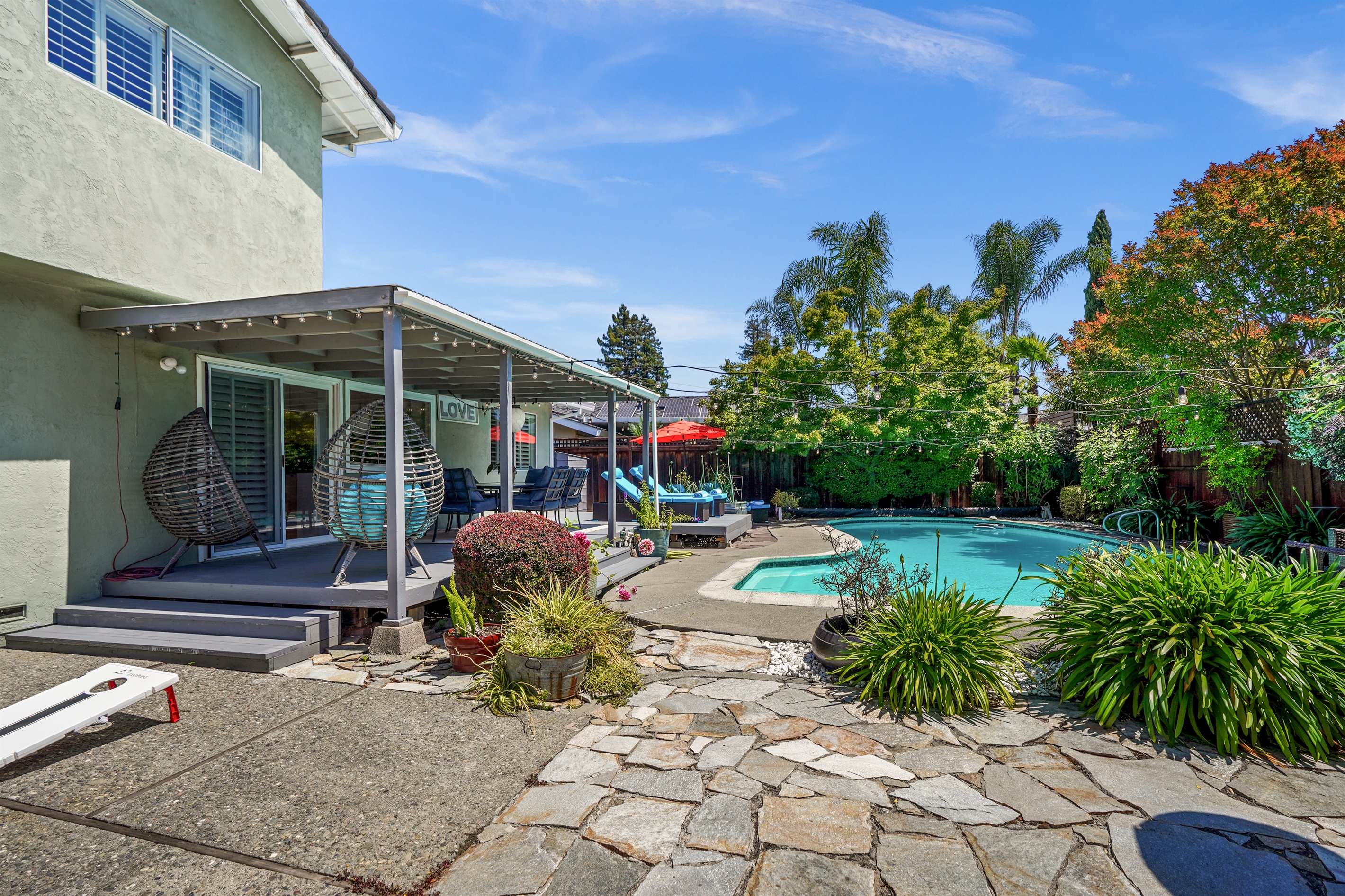 Private backyard retreat with a sparkling pool, outdoor seating, and space to relax and enjoy Napa Valley’s beautiful weather.