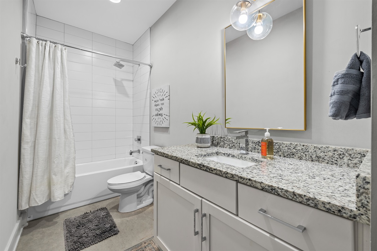 Bathroom Oasis: Sleek granite counters and modern fixtures await your refreshing retreat!