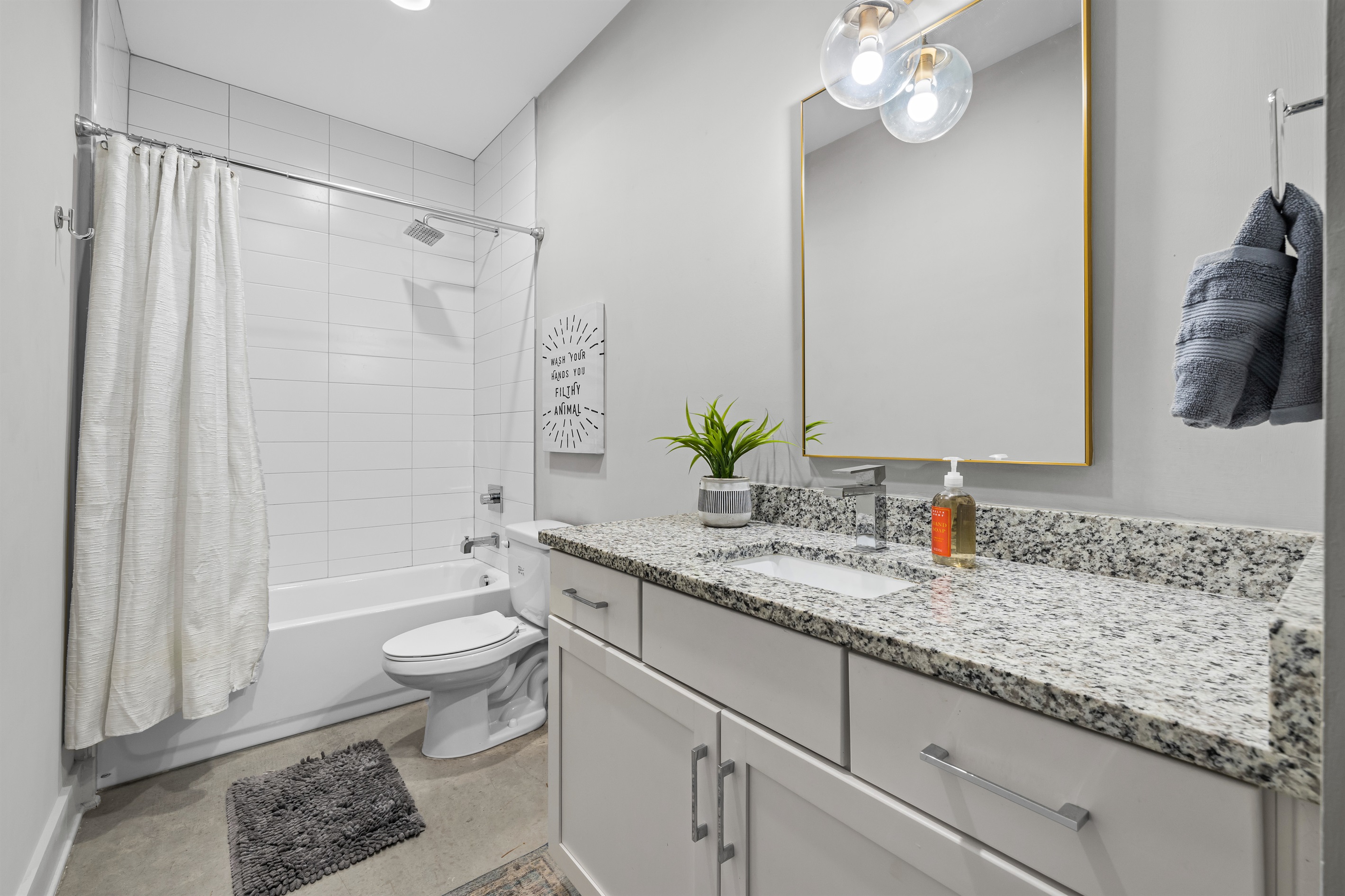 Bathroom Oasis: Sleek granite counters and modern fixtures await your refreshing retreat!