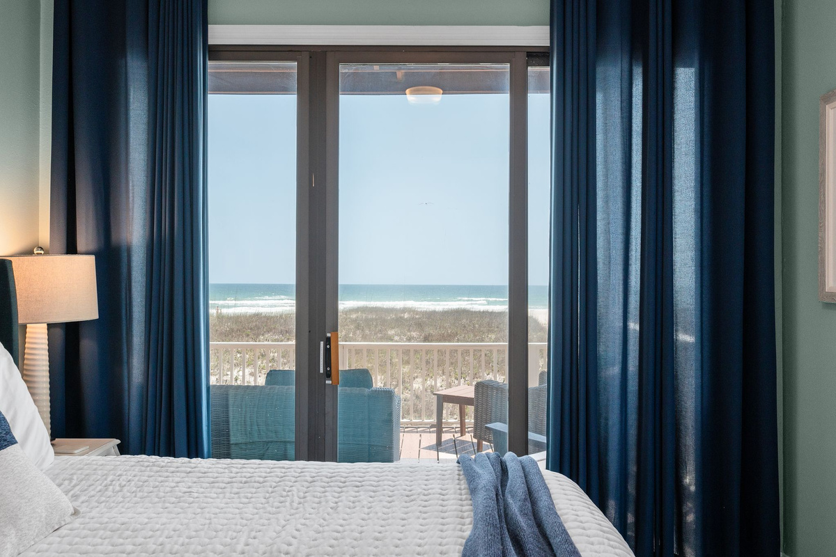 Relax in comfort with a private ensuite and seamless access to the deck, where panoramic gulf views await.