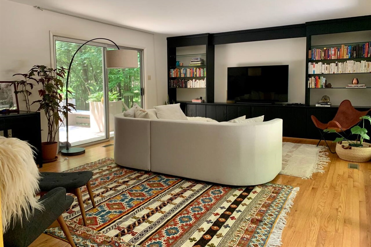 Two handwoven Moroccan rugs make this room feel spacious and luxurious. Not pictured, but just behind you and to the left: One of three fireplaces within the home.