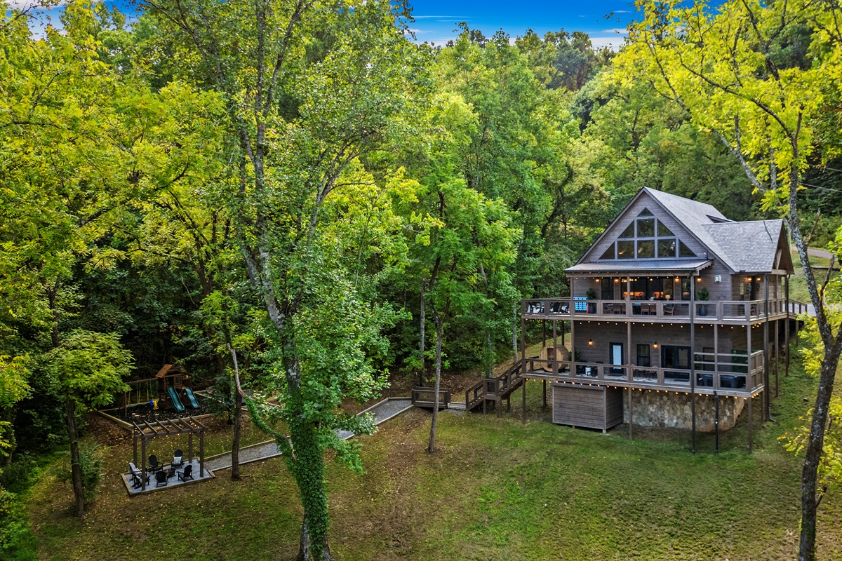 🏡 Big porch energy + playground joy. Whether you're sipping coffee or pushing kiddos on the swings, this is what cabin dreams are made of.