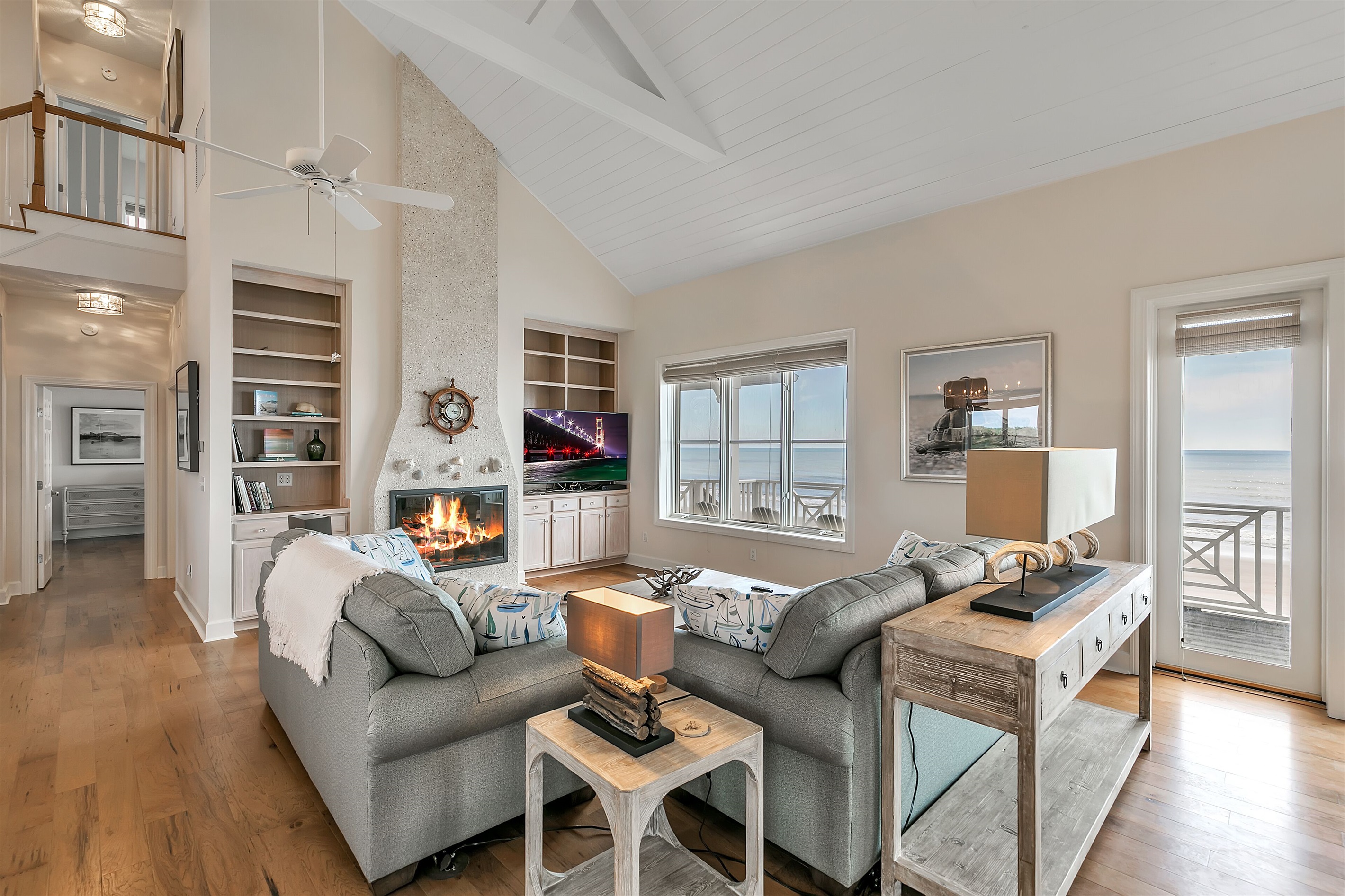 Tall ceilings and a fireplace flank this cozy family room with great views!