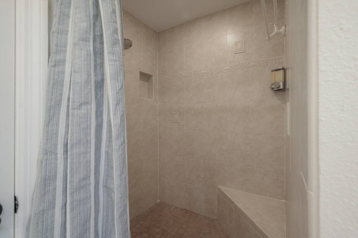 A practical shower design with a built-in niche and seating area.