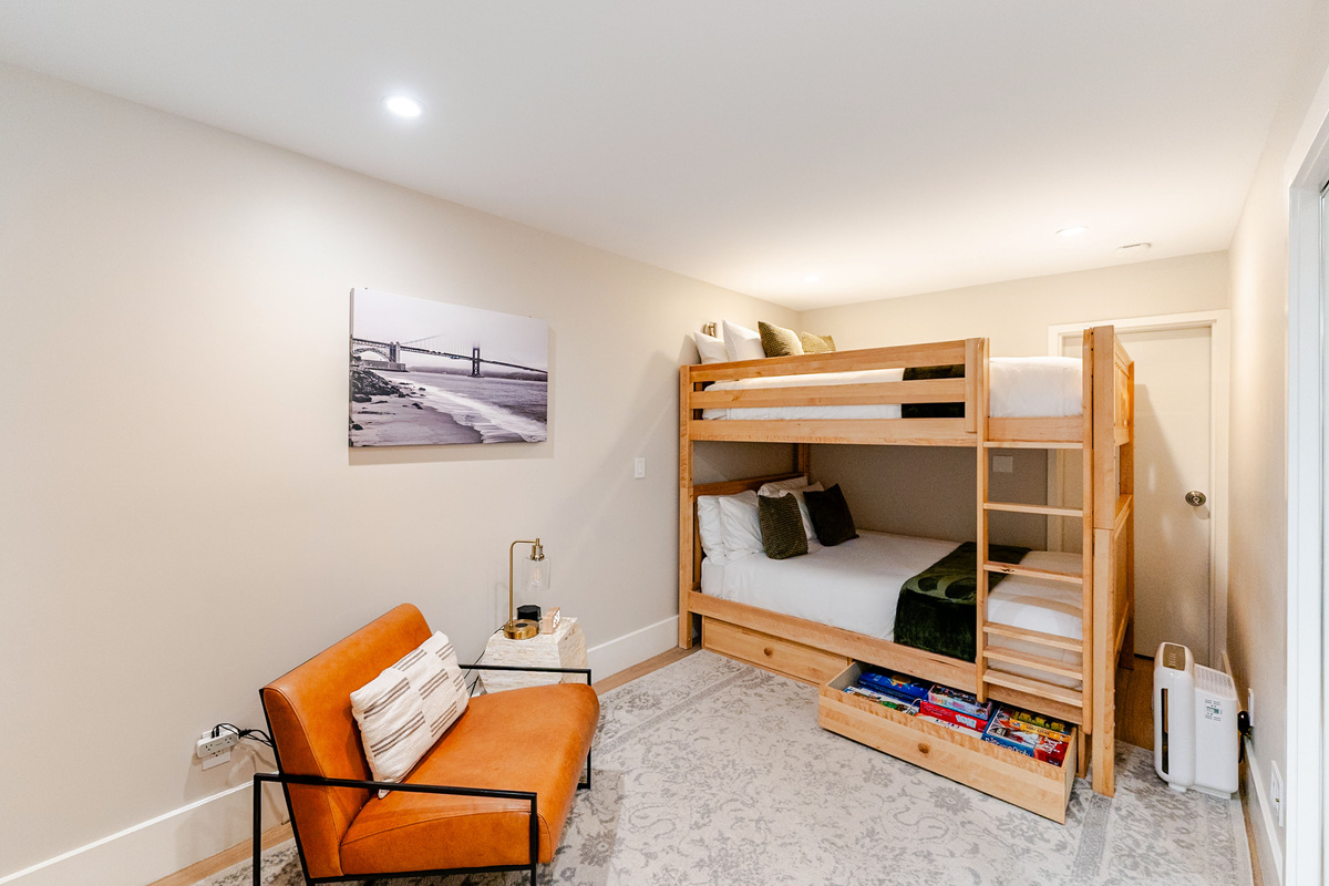 3rd Bedroom with adult-sized bunk beds w/ brand new Top-Rated mattresses and luxury bedding, large drawers & built-in closet for storage, lounge chair with reading light, built-in desk area and en suite jack-and-jill bathroom with jetted tub