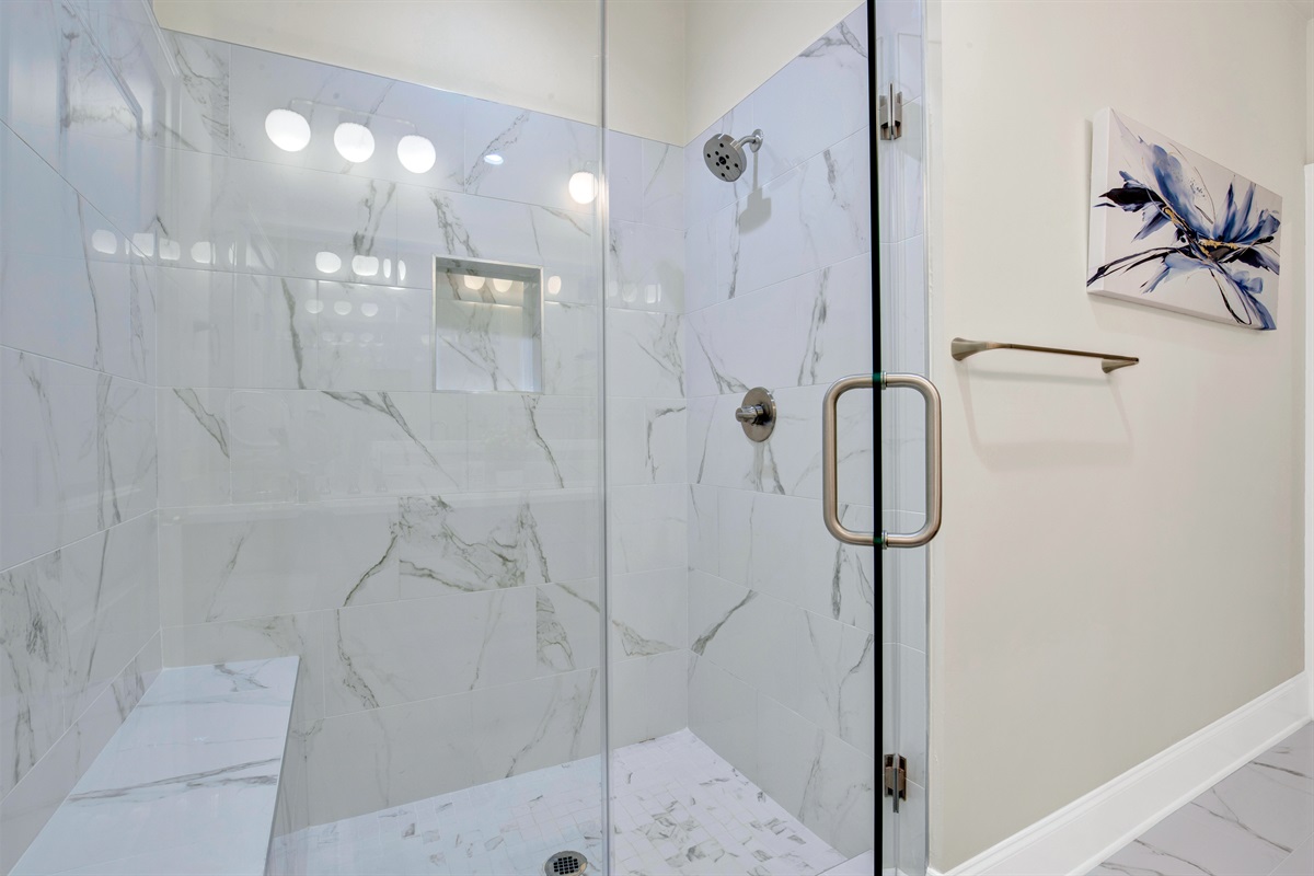 Primary King size ensuite bathroom shower with seat and niche