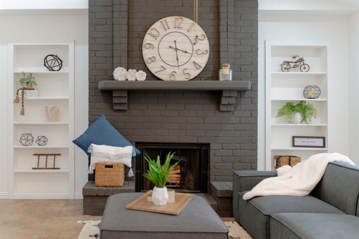 Open living room with fireplace and stylish decor.