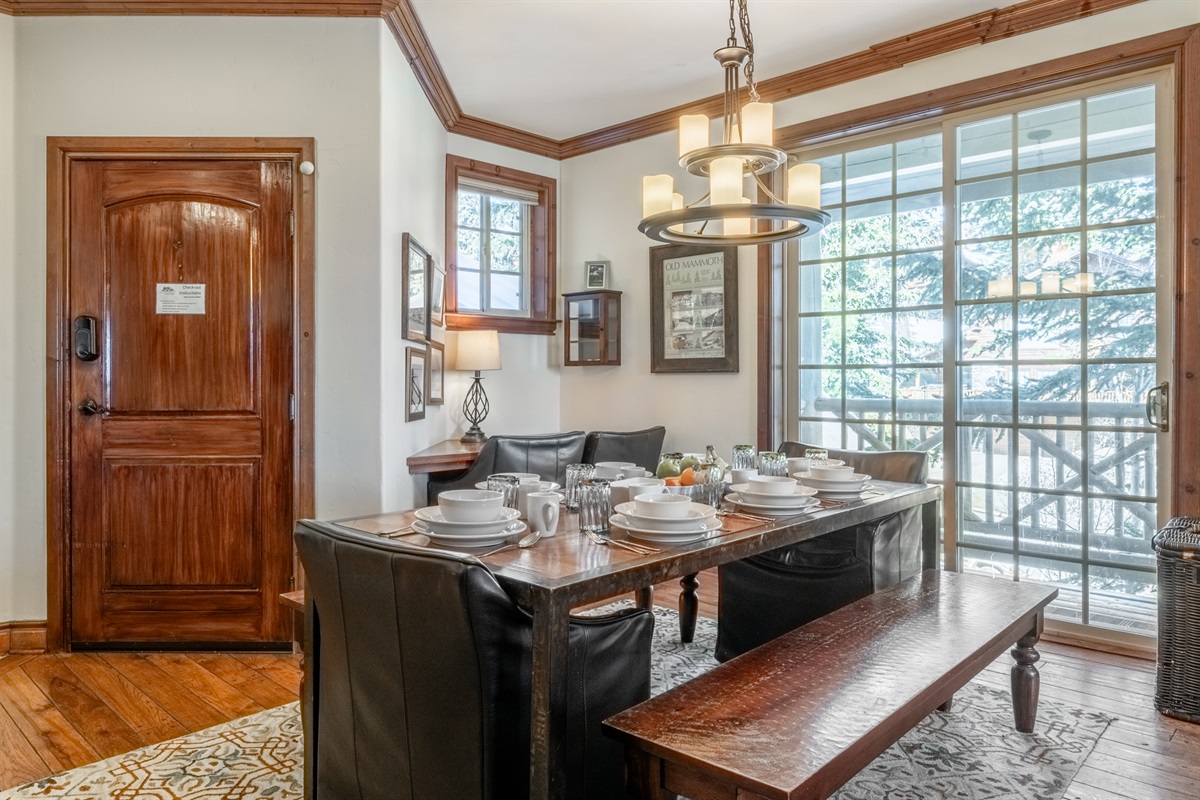 Light-filled dining area with floor-to-ceiling windows and a dedicated workspace, tucked in the corner.