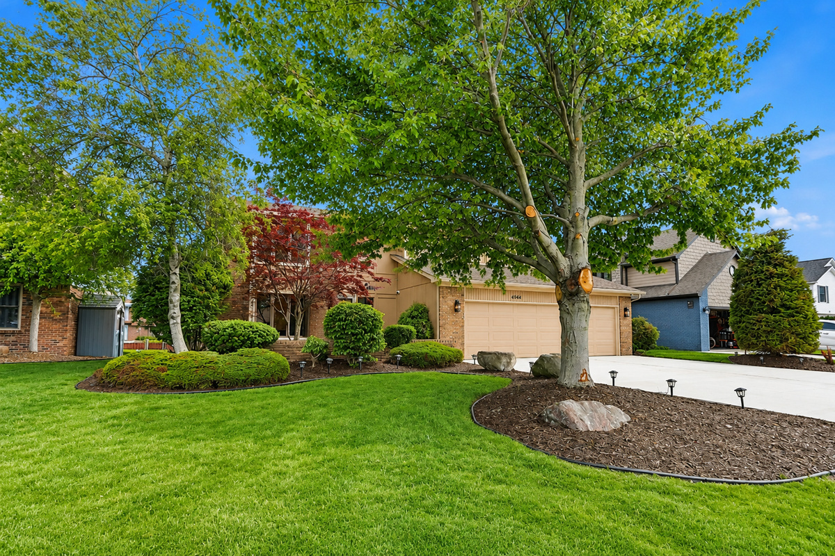 XX Spacious front yard with mature trees, manicured lawn, and a quiet suburban setting. Well-maintained curb appeal in a peaceful residential neighborhood.