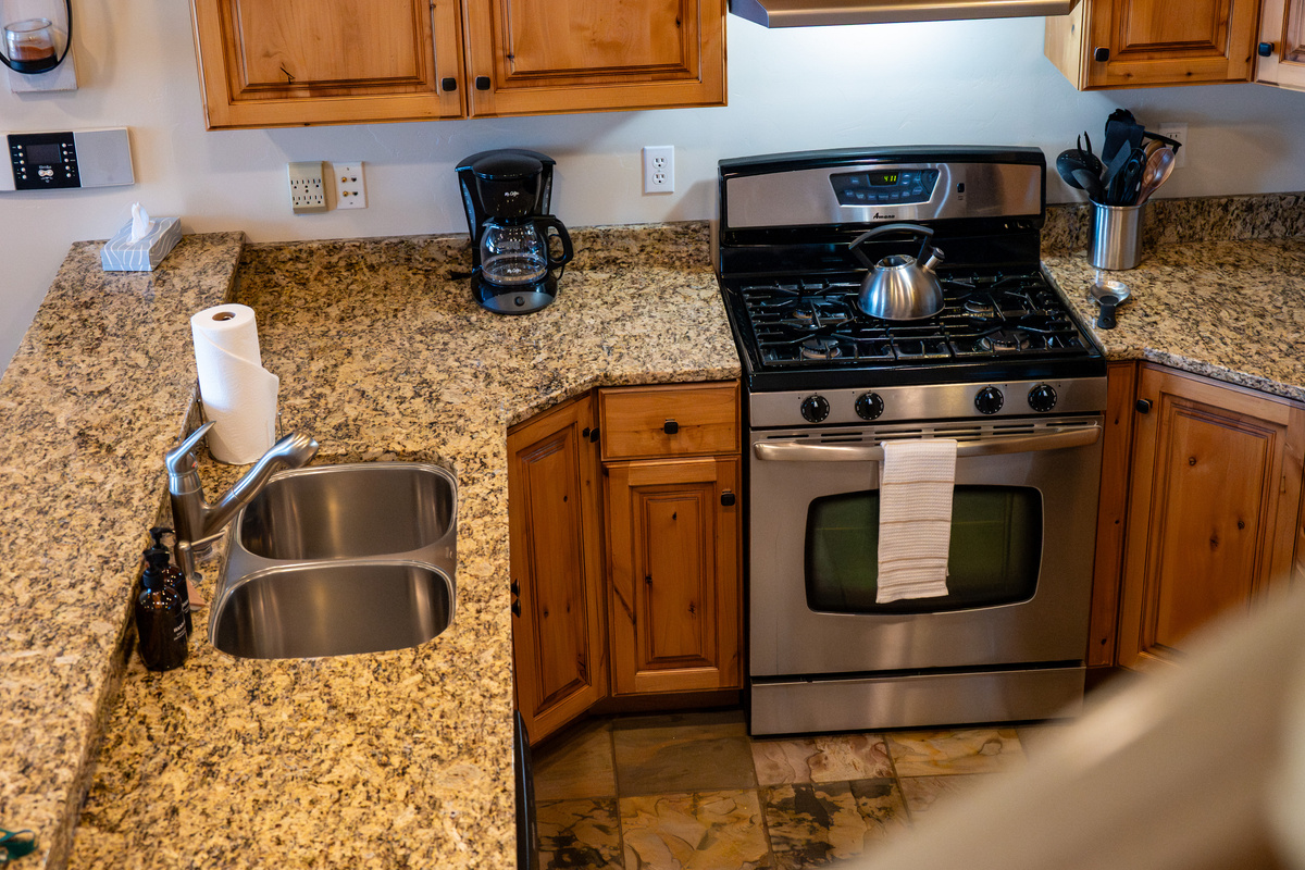 Functional kitchen workspace with granite countertops and double sink.