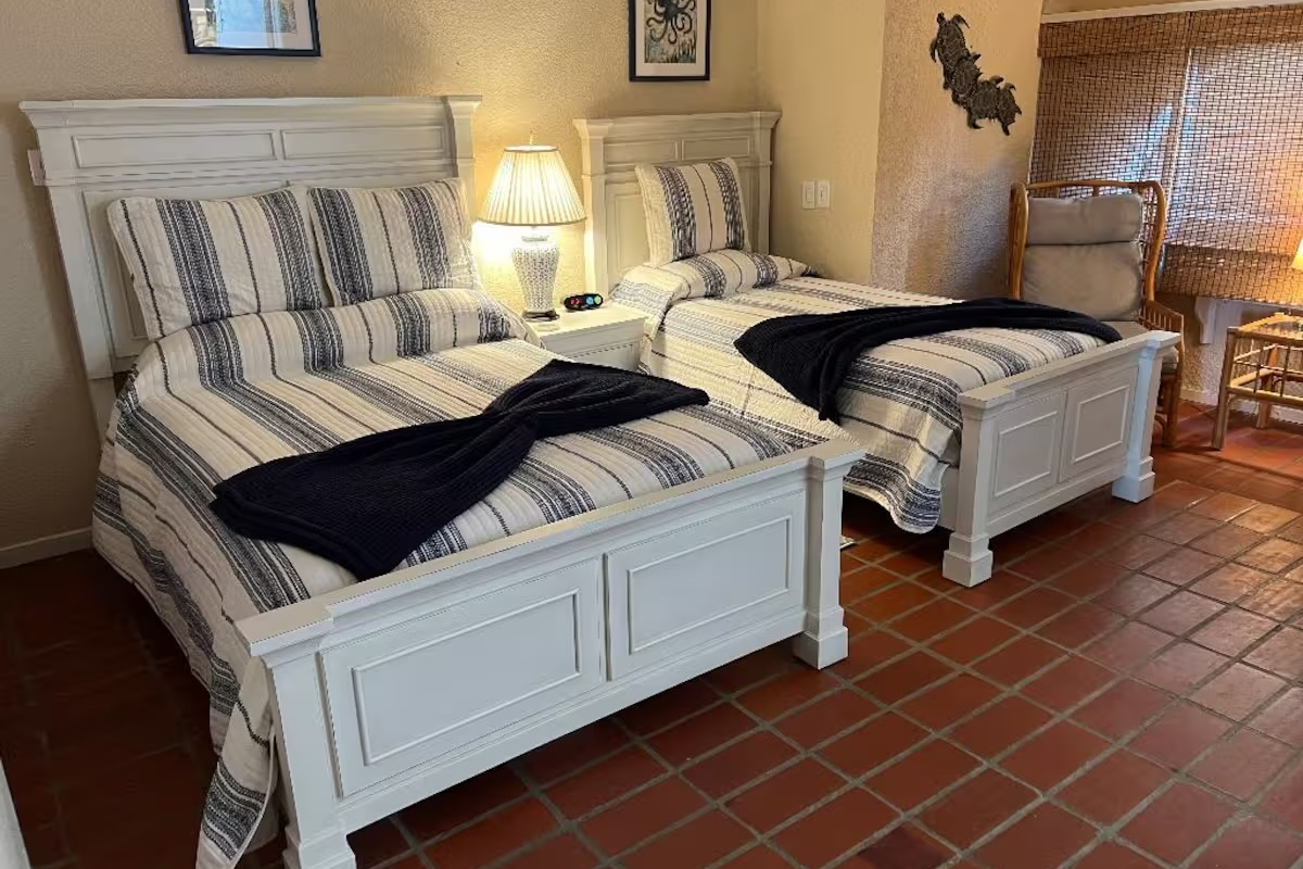 Comfortable guest bedroom featuring two twin beds.